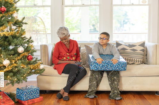 Black boy receiving gift from grandparents