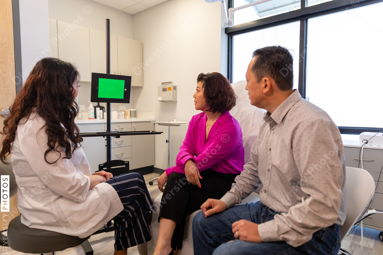 Telehealth and remote translation professional consults patients in medical exam room