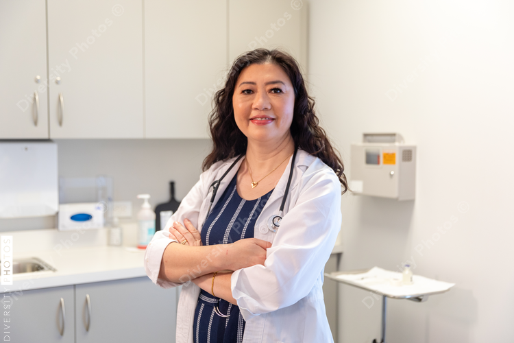 Portrait of middle aged Chinese doctor in a medical exam room