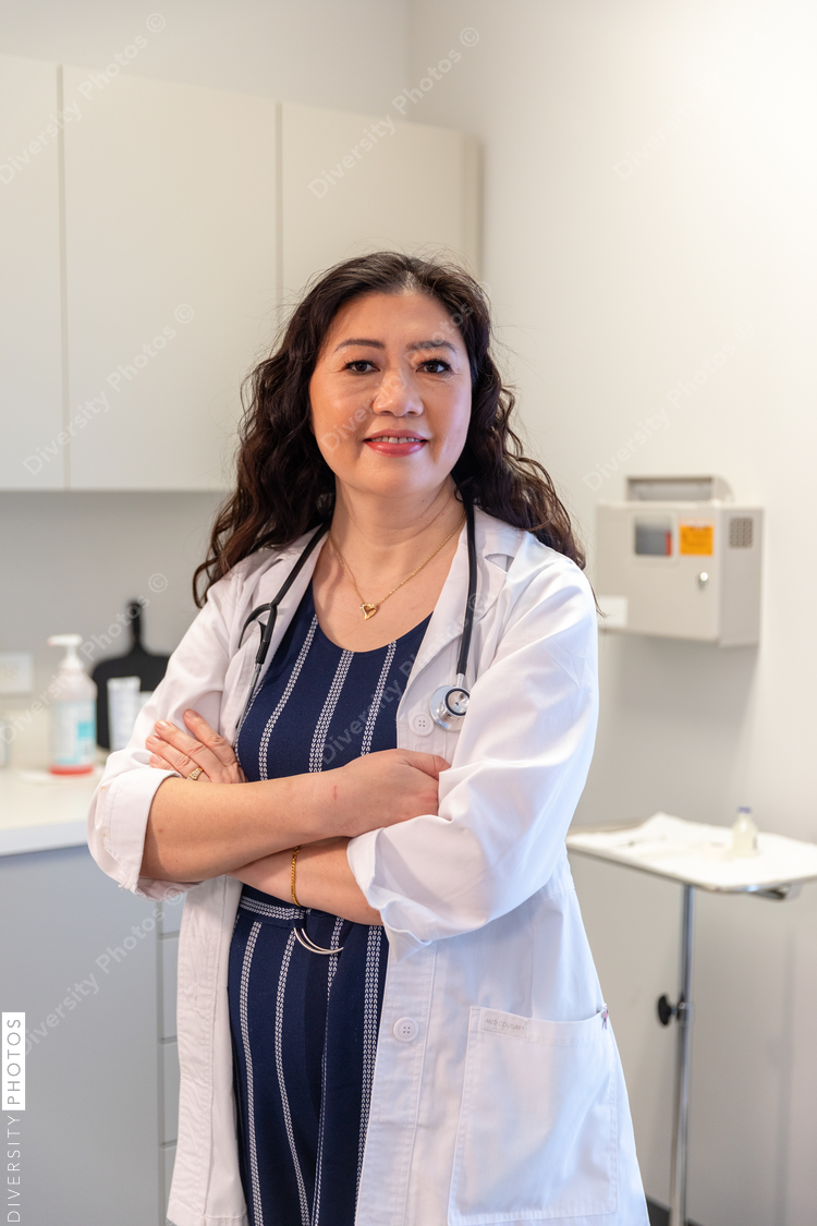 Portrait of middle aged Chinese doctor in a medical exam room
