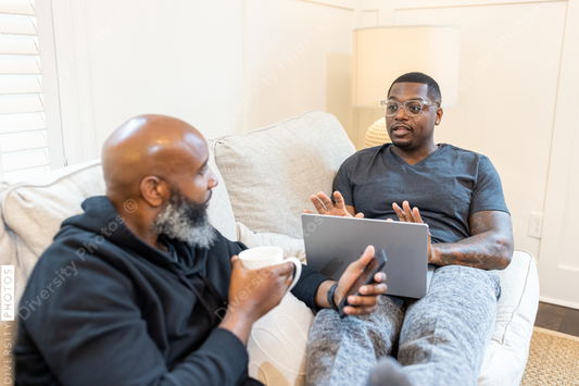 Black gay couple at home in living room, loving relationship