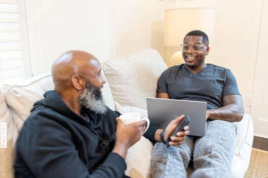 Black gay couple at home in living room, loving relationship