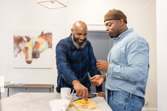 Black gay couple in kitchen at home, playful moment, conversations