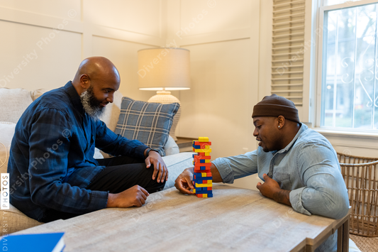 African American gay couple has game night at home