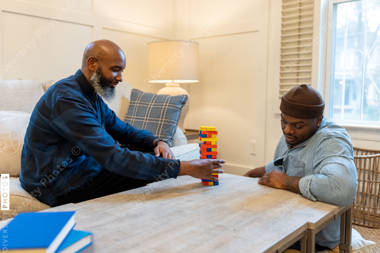 African American gay couple has game night at home