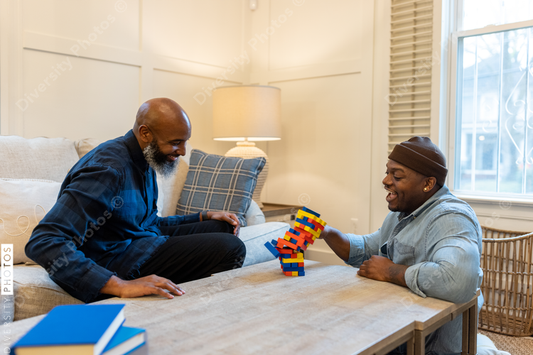 African American gay couple has game night at home