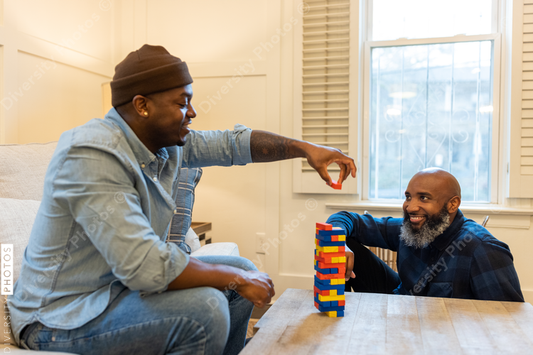 African American gay couple has game night at home