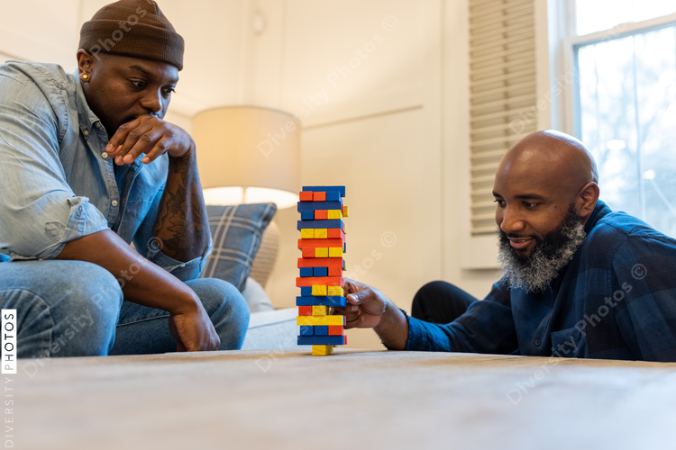 African American gay couple has game night at home