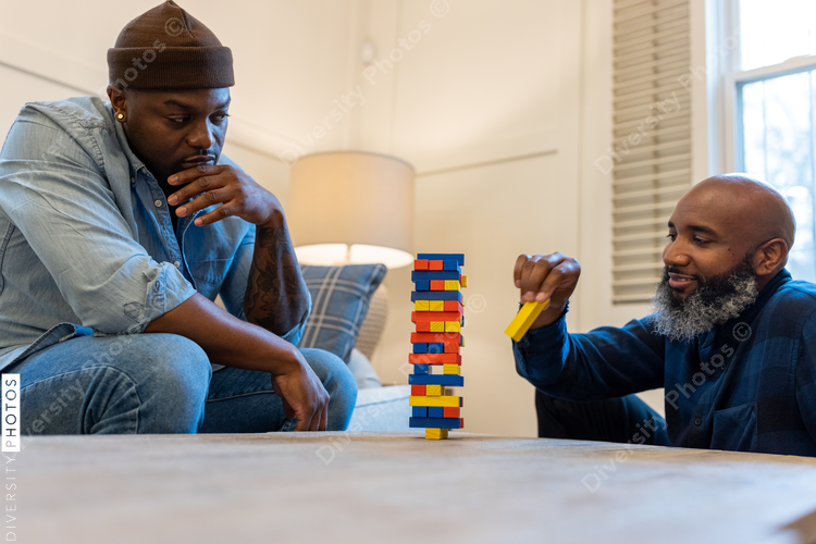 African American gay couple has game night at home