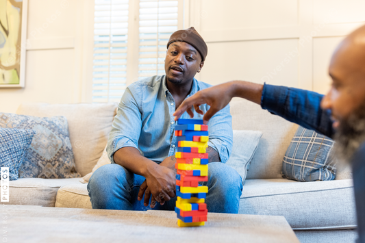 African American gay couple has game night at home