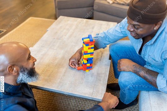 African American gay couple has game night at home