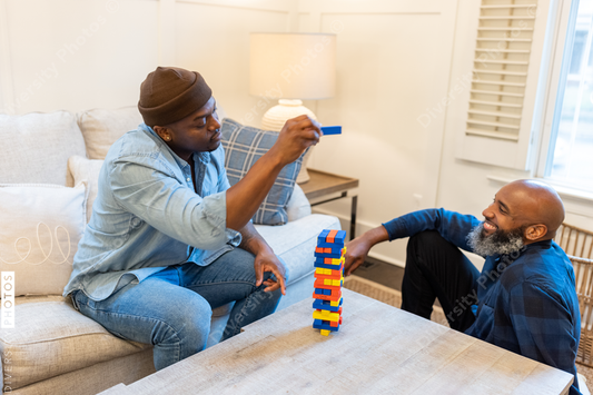 African American gay couple has game night at home
