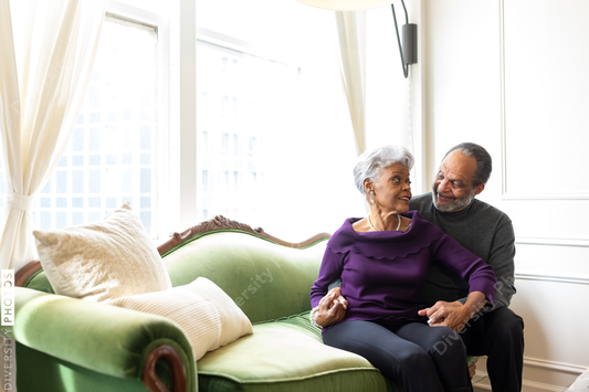 African American senior couple at home on couch, relationship connections
