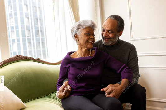 African American senior couple at home on couch, relationship connections