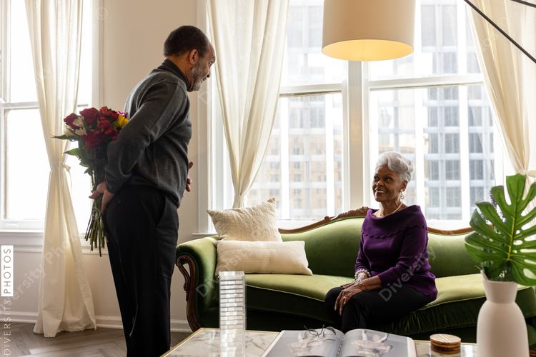 Senior man surprises wife with flowers, celebrating valentines day
