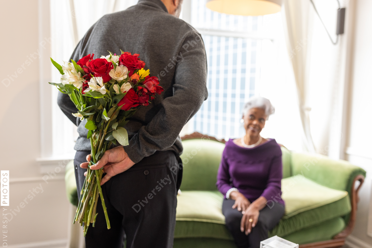 Senior man surprises wife with flowers, celebrating valentines day