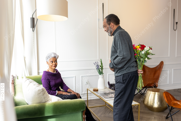 Senior man surprises wife with flowers, celebrating valentines day
