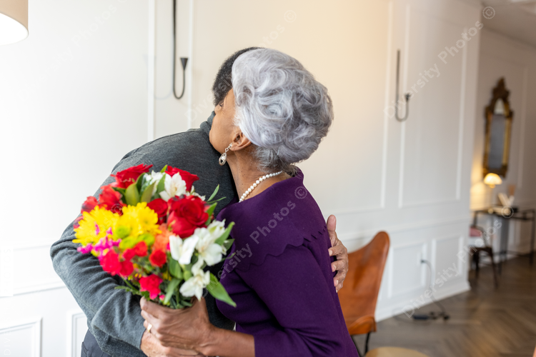 Black senior couple hugging at home, connectedness moments