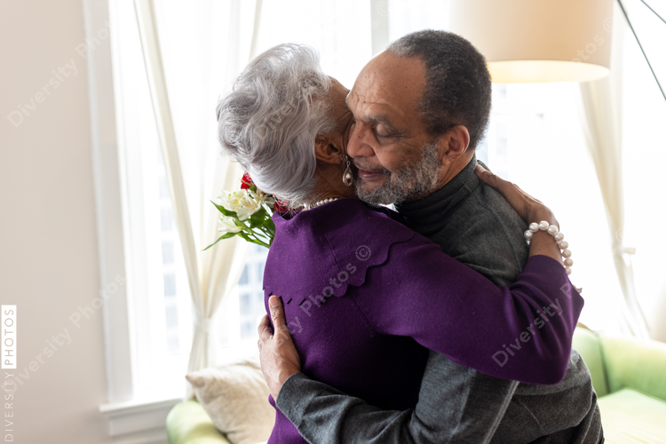 Black senior couple hugging at home, connectedness moments