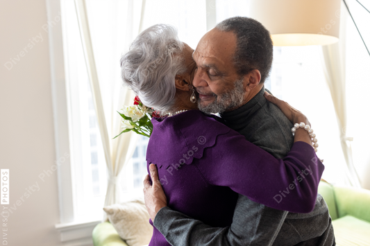Black senior couple hugging at home, connectedness moments