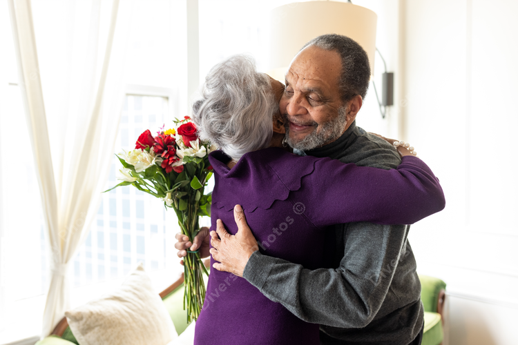 Black senior couple hugging at home, connectedness moments