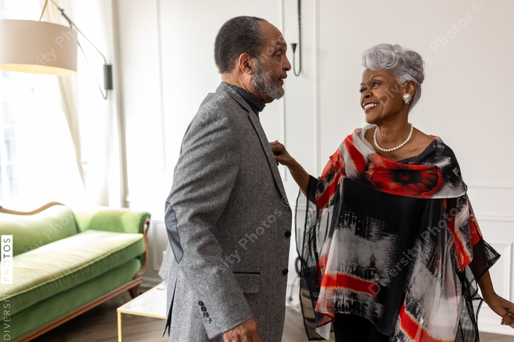 Smiling senior couple dancing at home, togetherness